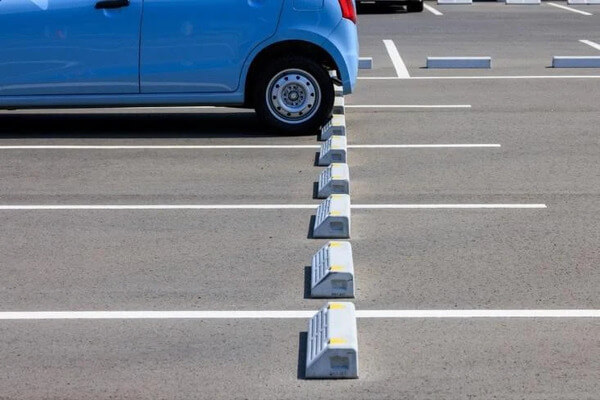 What are the benefits of installing parking barriers for businesses